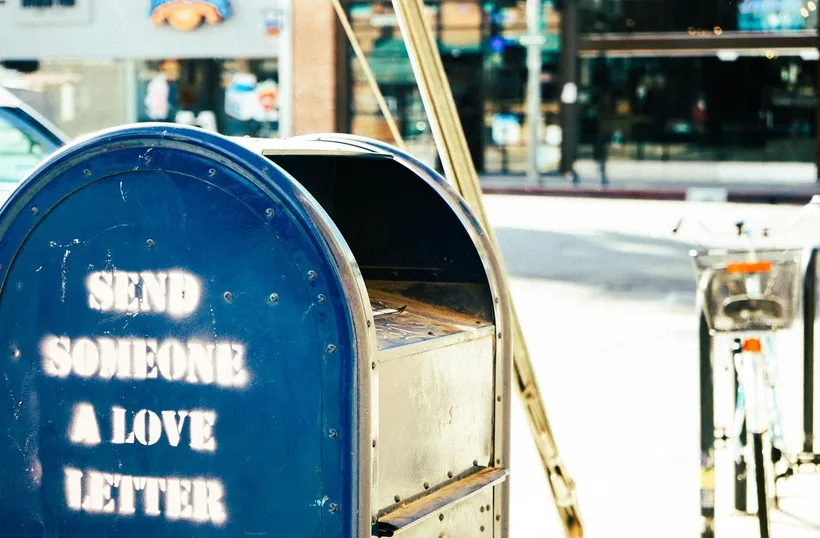 A mailbox painted with the words Send Someone A Love Letter